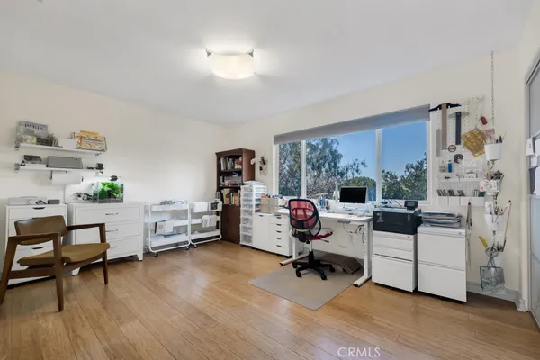 a view of a livingroom with workspace and a window