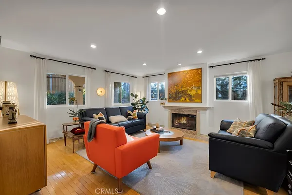 a living room with fireplace furniture and a flat screen tv