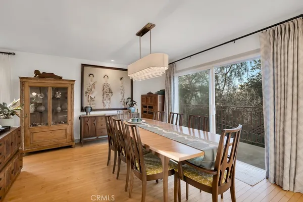 a dining room with furniture window and wooden floor