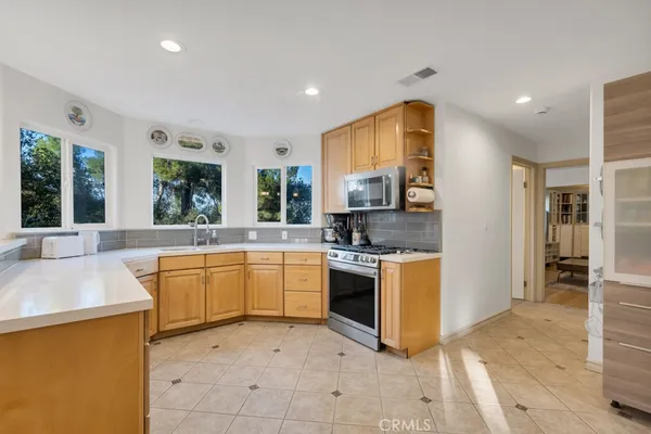 a kitchen with stainless steel appliances granite countertop a sink and a stove