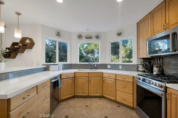 a kitchen with a sink stove and cabinets
