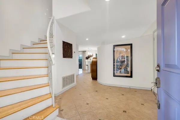 a view of a livingroom with wooden floor and white walls