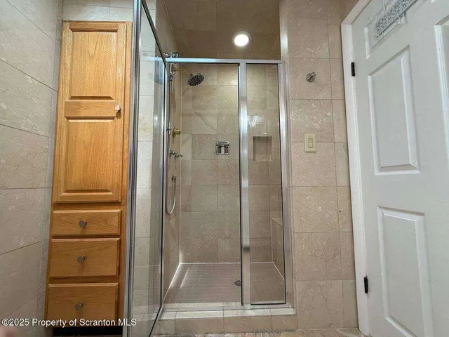 a bathroom with a glass shower door