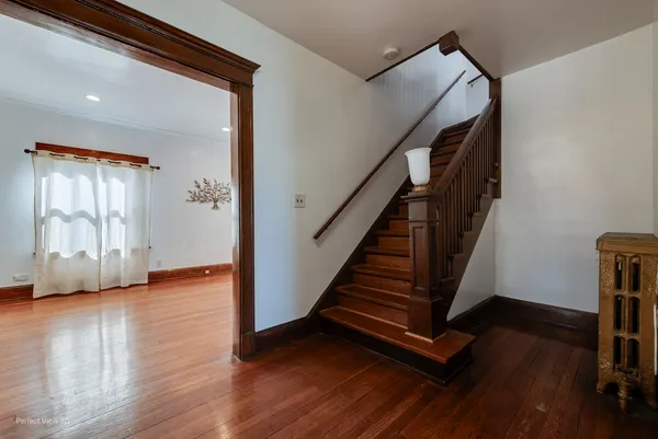 a view of an entryway with wooden floor and door