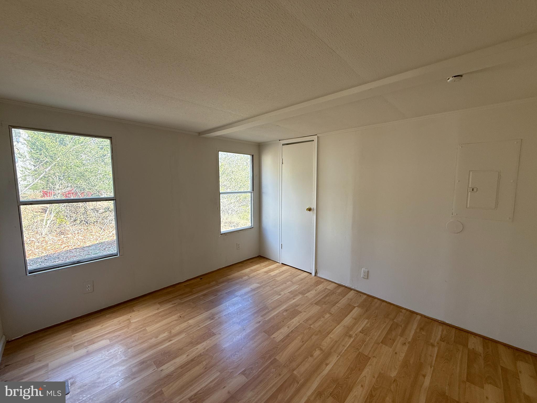 3611 Shirleys Hill Road Partlow, VA 22534 - Photo 12 of 25 a view of an empty room with wooden floor and a window