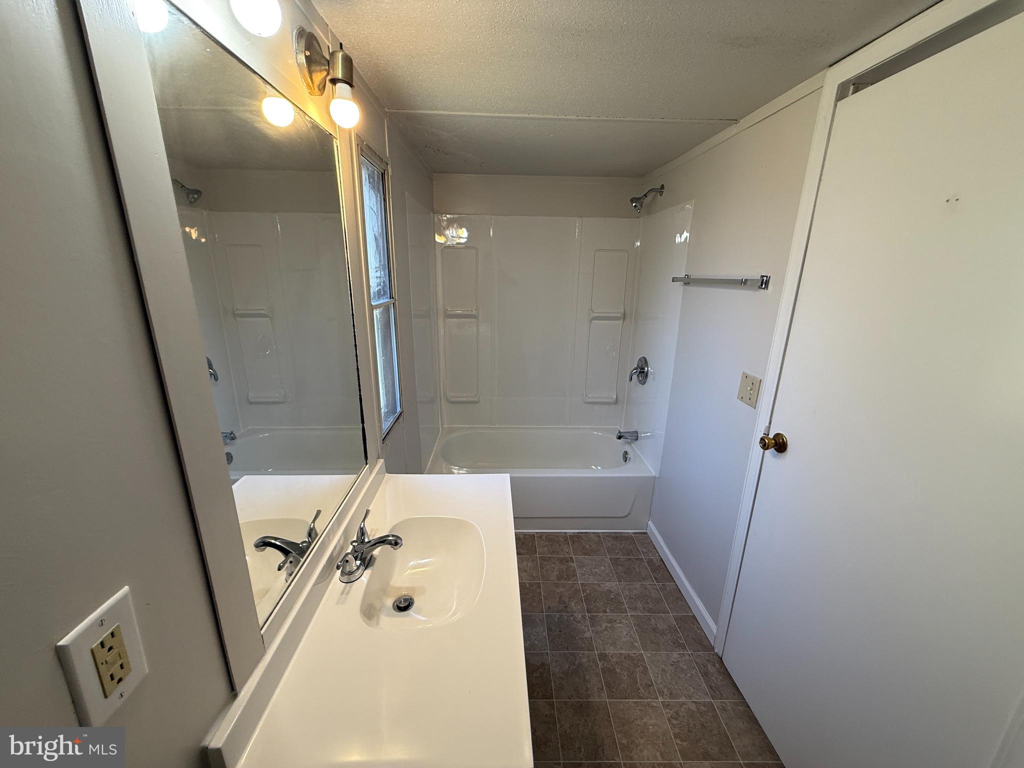 3611 Shirleys Hill Road Partlow, VA 22534 - Photo 16 of 25 a bathroom with a tub a sink and shower