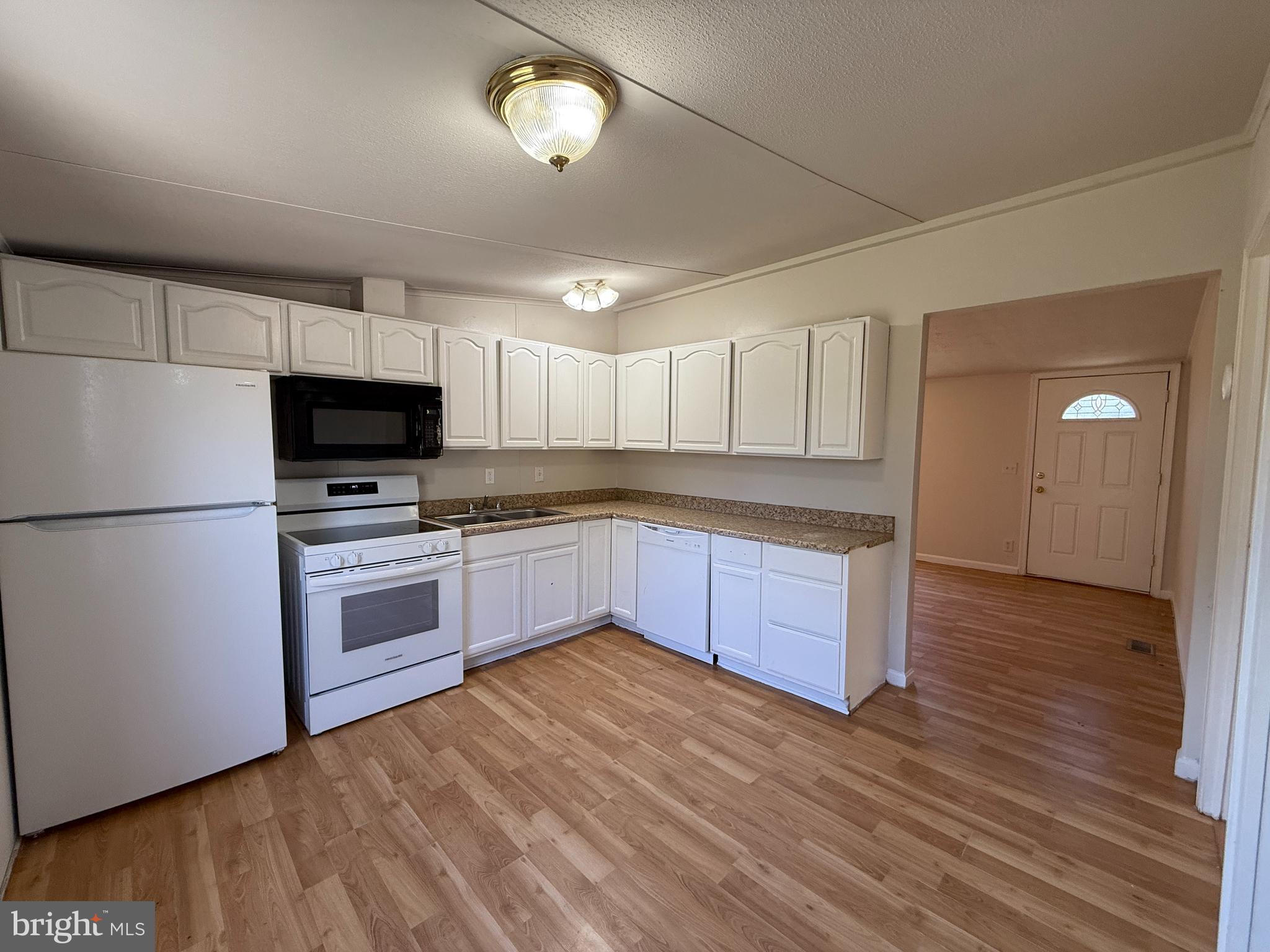 3611 Shirleys Hill Road Partlow, VA 22534 - Photo 18 of 25 a kitchen with granite countertop a refrigerator and a stove top oven