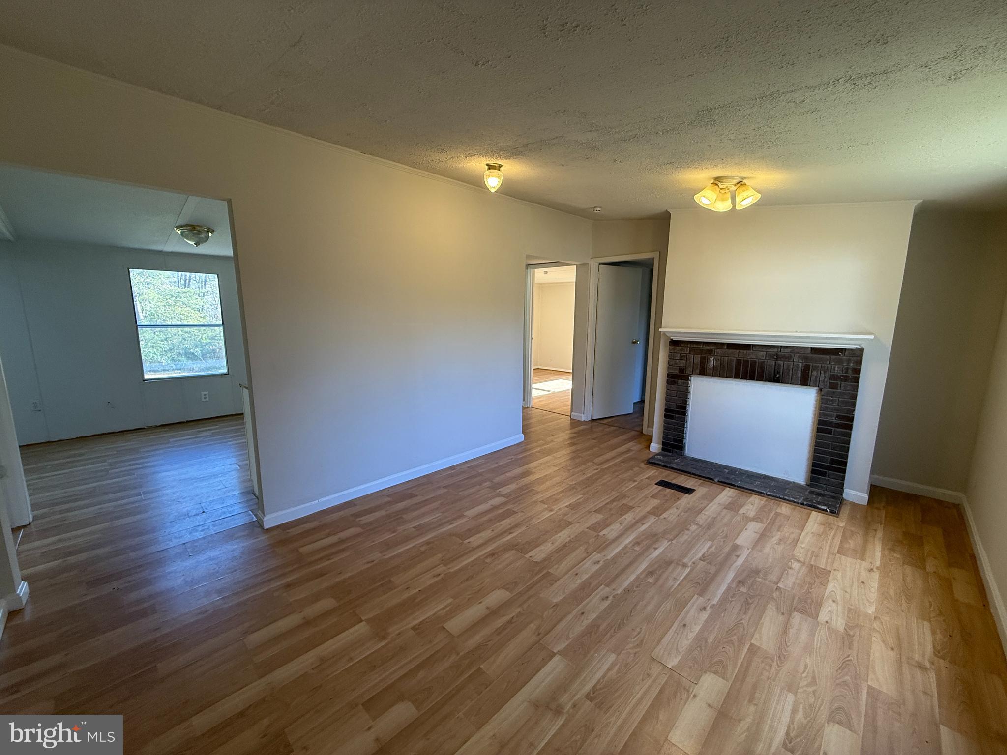 3611 Shirleys Hill Road Partlow, VA 22534 - Photo 4 of 25 an empty room with wooden floor and windows