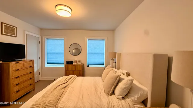 a view of a living room with a flat screen tv and refrigerator