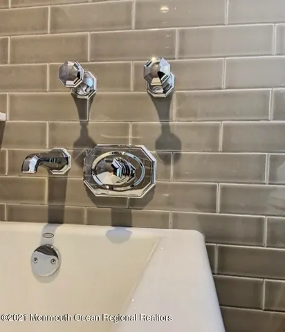 a room with furniture a flat screen tv and a window