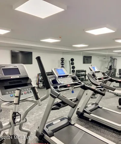 a lobby with furniture and potted plants