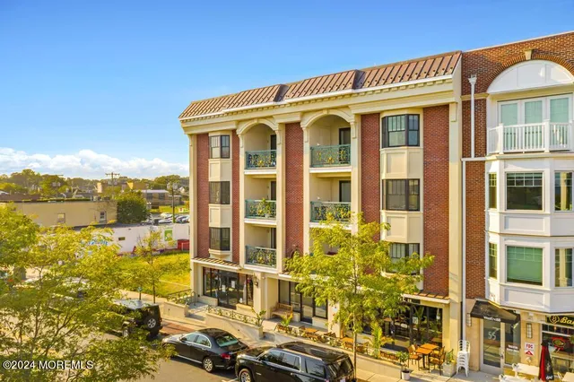 a kitchen with stainless steel appliances a sink a stove a refrigerator and cabinets