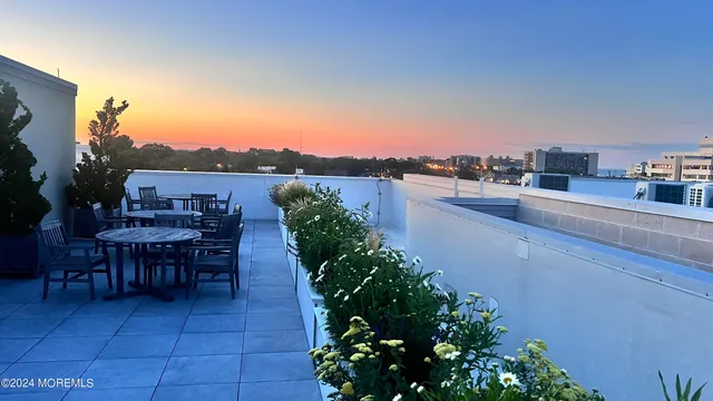 a kitchen with stainless steel appliances a sink a stove a refrigerator and cabinets