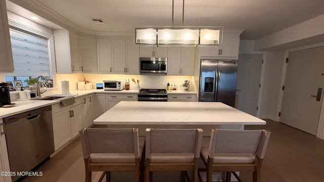 a view of living room with furniture and white walls