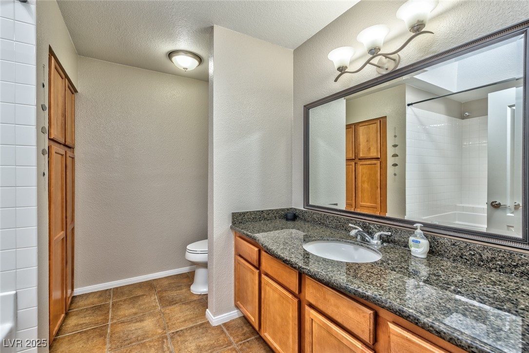 3145 East Flamingo Road, Unit 2068 Las Vegas, NV 89121 - Photo 11 of 15 Full bath with vanity, a textured wall, a textured ceiling, and shower / tub combination
