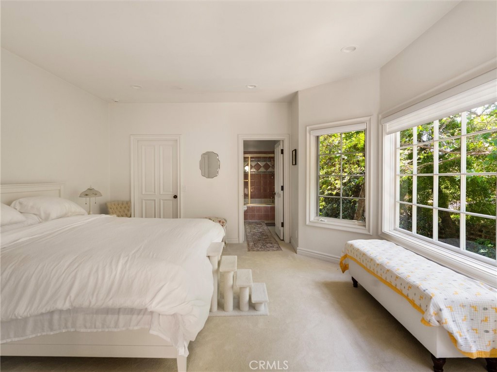 6000 Cavalleri Road Malibu, CA 90265 - Photo 39 of 44 a spacious bedroom with a bed and a large window