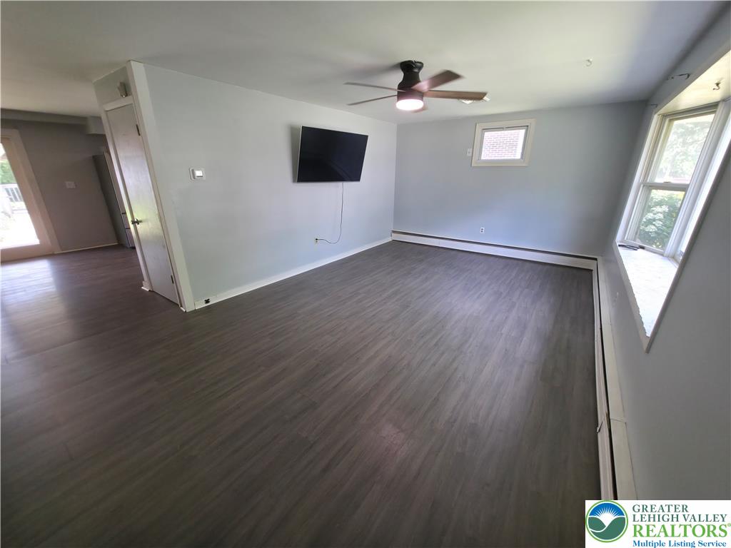 719 Keystone Avenue Bethlehem, PA 18018 - Photo 8 of 32 A versatile living area with abundant natural light from wide windows and dark-toned flooring.