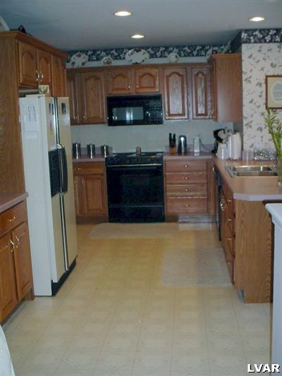 1273 Miller Road Wind Gap, PA 18091 - Photo 7 of 17 a kitchen with stainless steel appliances granite countertop a refrigerator and a stove