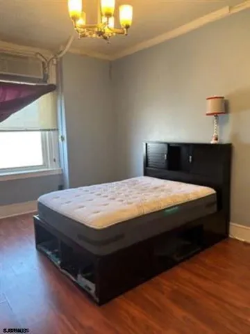 a view of a room with wooden floor and a sink