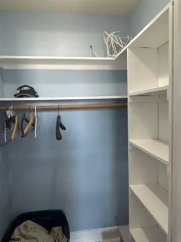 a view of a room with wooden floor cabinet and a window