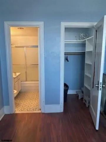 a view of walk in closet with empty racks