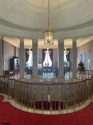 a view of a very nice looking dining room with furniture wooden floor and chandelier