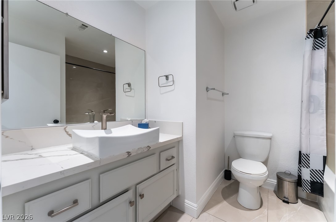 9028 Cypress Point Road Las Vegas, NV 89117 - Photo 26 of 39 A well-appointed bathroom features a contemporary vessel sink atop a marble vanity.