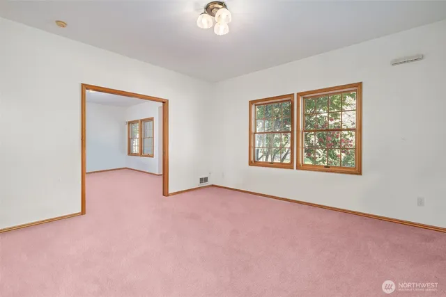 an empty room with windows and closet
