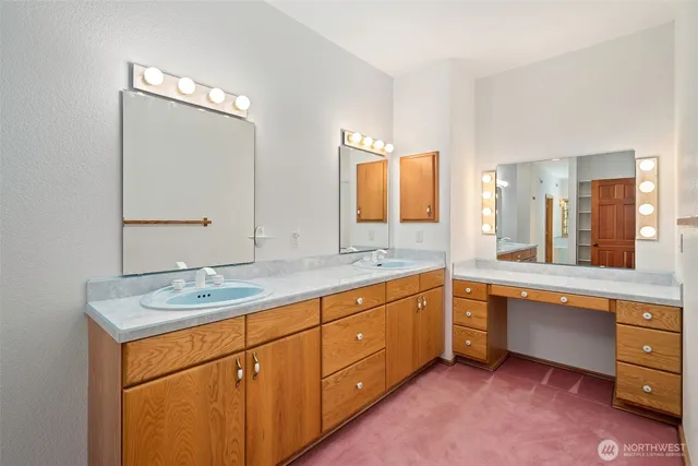 a spacious bathroom with a granite countertop sink mirror and a