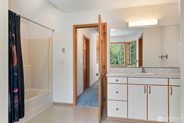 a bathroom with a double vanity sink and a bathtub