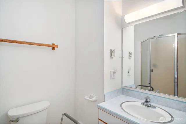 a bathroom with a sink a toilet and shower
