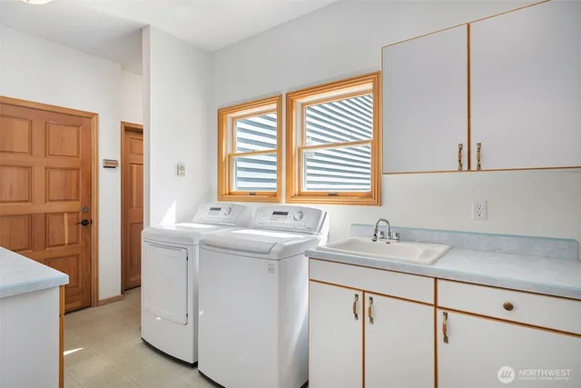 a bathroom with a sink and a washing machine
