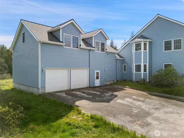 a view of a house with a yard and garage