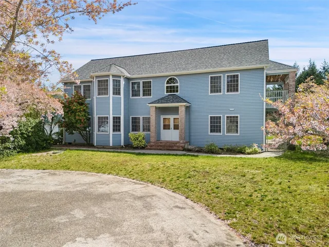 a front view of house with yard and green space