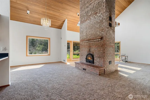 a view of a livingroom with fireplace and window