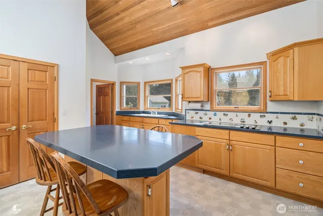 a kitchen with granite countertop a sink and cabinets