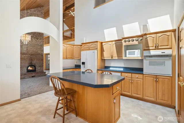 a kitchen with stainless steel appliances granite countertop a sink and a refrigerator