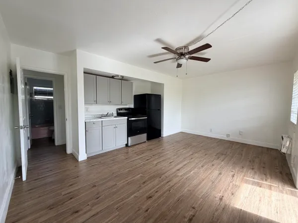 a view of a kitchen with a sink and a refrigerator