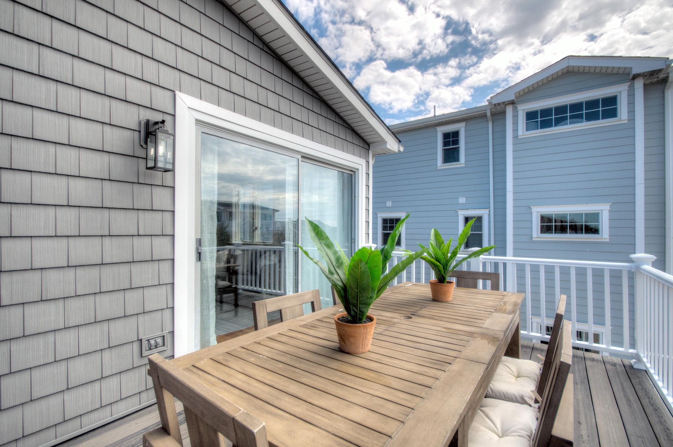 320 40th Street Avalon, NJ 08202 - Photo 13 of 39 a view of a deck with table and chairs with wooden floor and fence