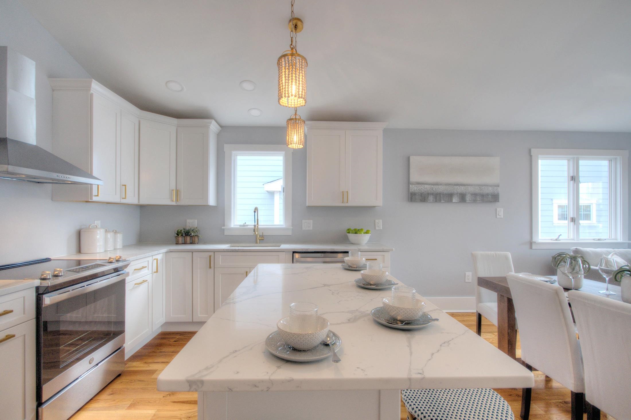 320 40th Street Avalon, NJ 08202 - Photo 15 of 39 a kitchen with a table chairs stove and cabinets
