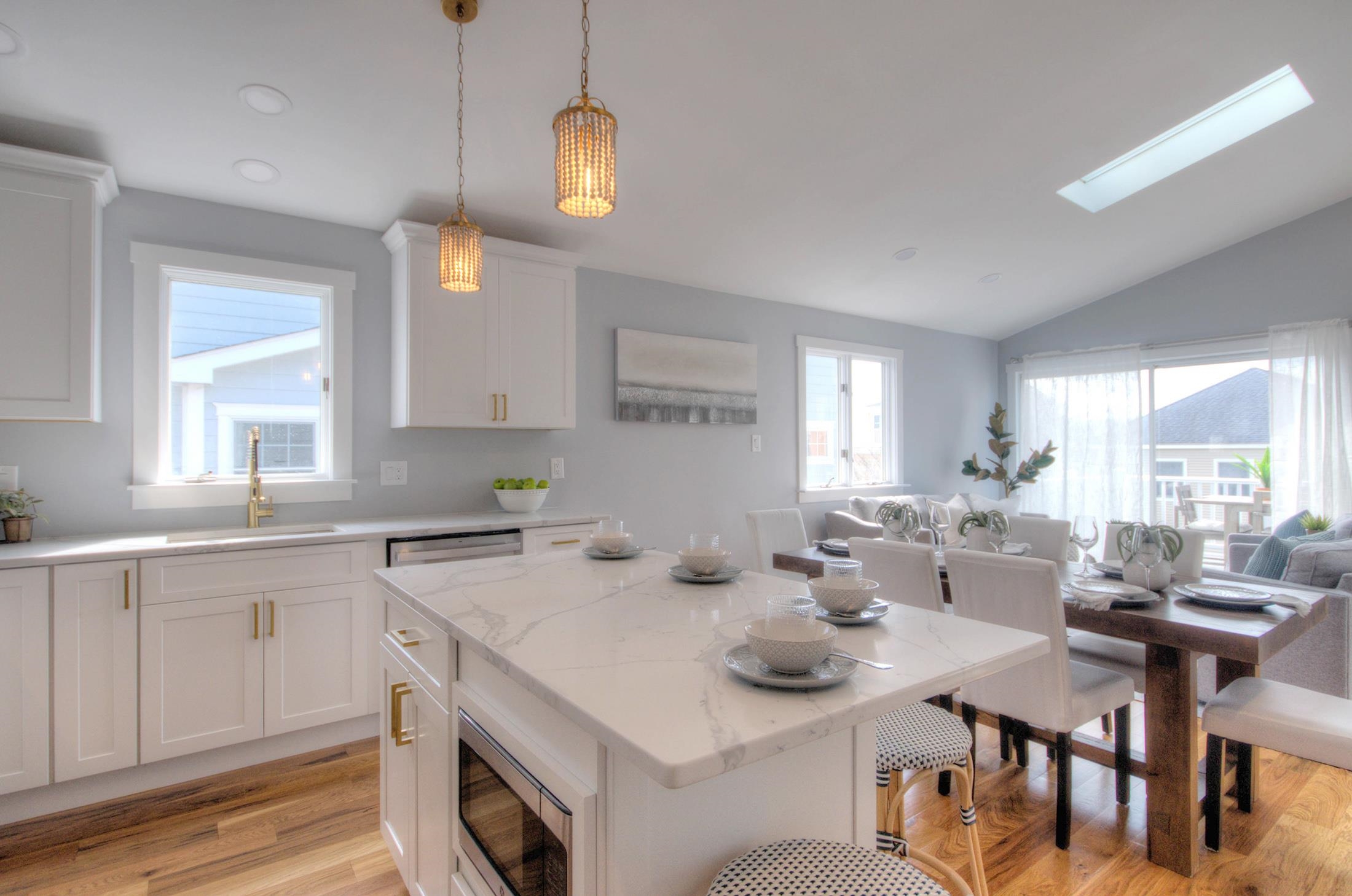 320 40th Street Avalon, NJ 08202 - Photo 16 of 39 a kitchen with a sink dining table and chairs