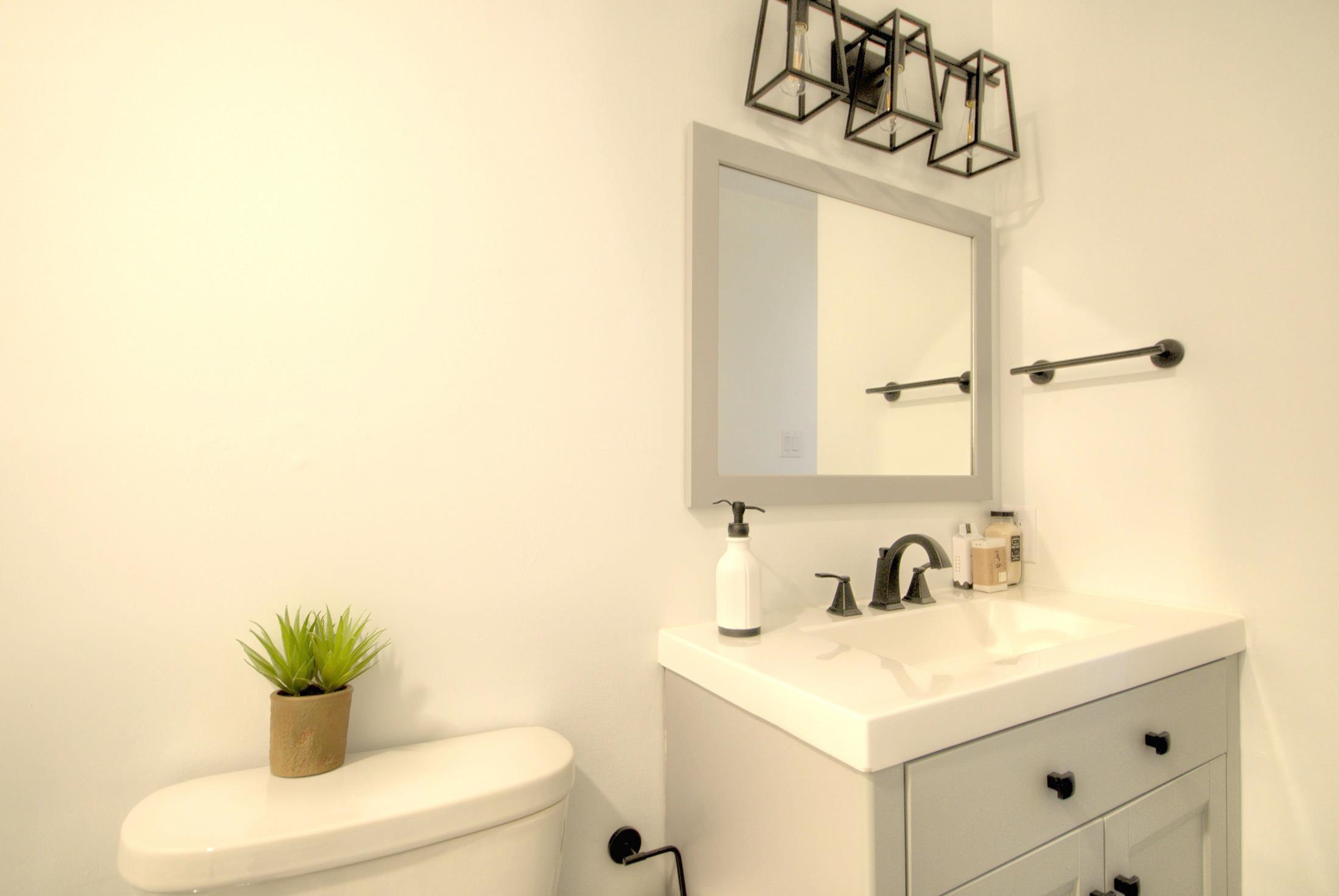 320 40th Street Avalon, NJ 08202 - Photo 37 of 39 a bathroom with a sink and a mirror