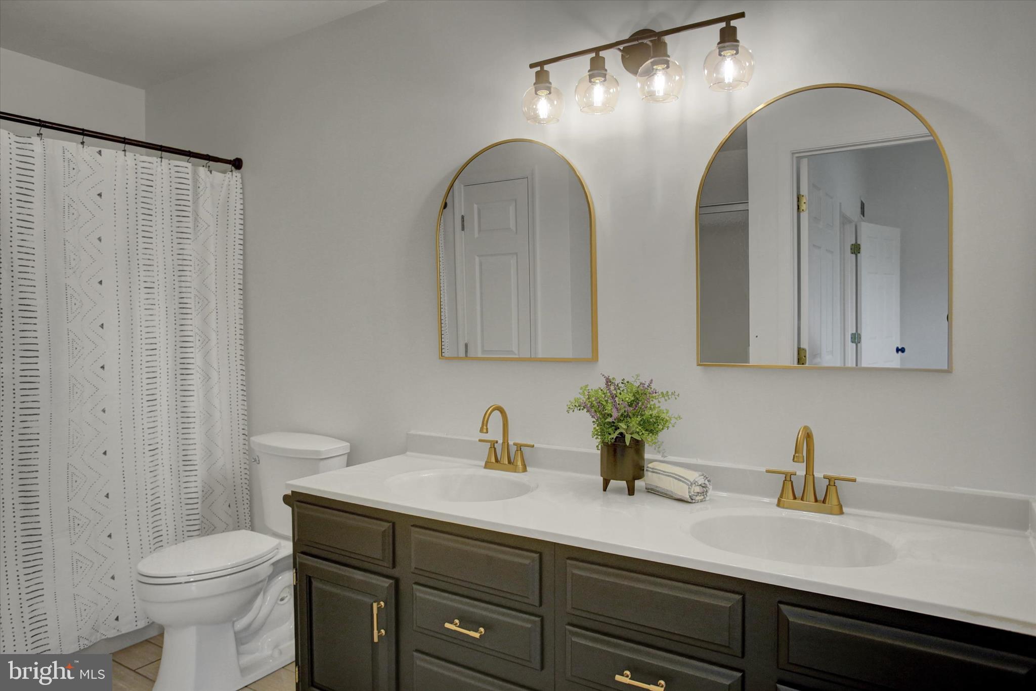 1553 Brechbill Road Chambersburg, PA 17202 - Photo 29 of 45 a bathroom with a double vanity sink mirror and toilet