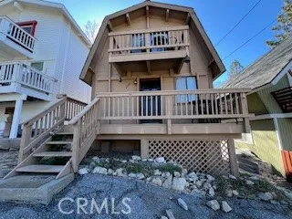 a view of a house with wooden deck