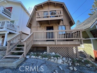 a view of a house with wooden deck