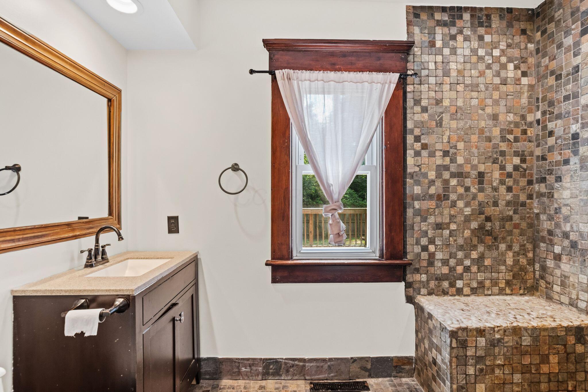 107 Price Road Columbus, OH 43230 - Photo 13 of 51 Bathroom featuring a dark wood vanity with a light-toned countertop and an undermount sink