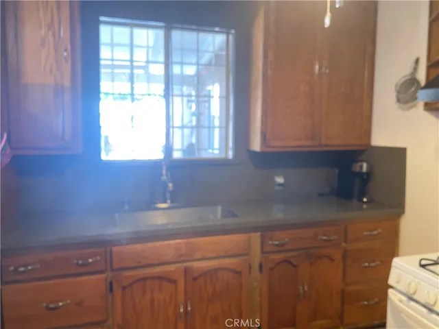 a kitchen with granite countertop a sink and a window