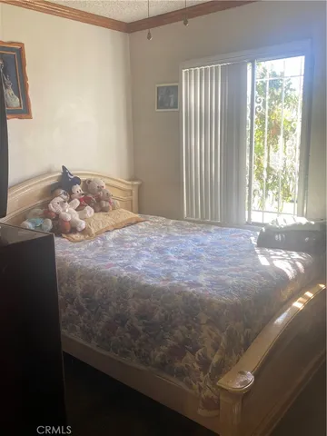 a bedroom with a bed and window