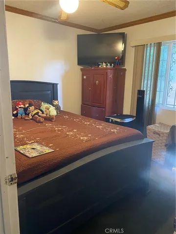 a bed sitting in a bedroom next to a window