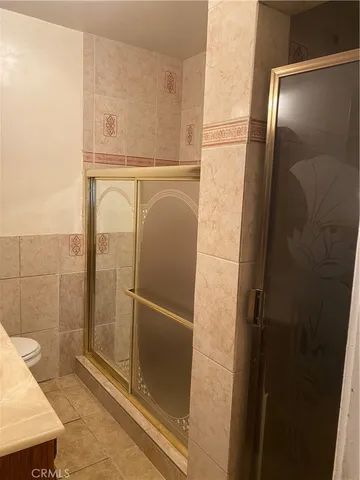 a bathroom with a glass shower door